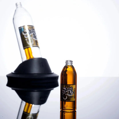 Slum 45 malt liquor bottle with black silicone adapter on reflective surface