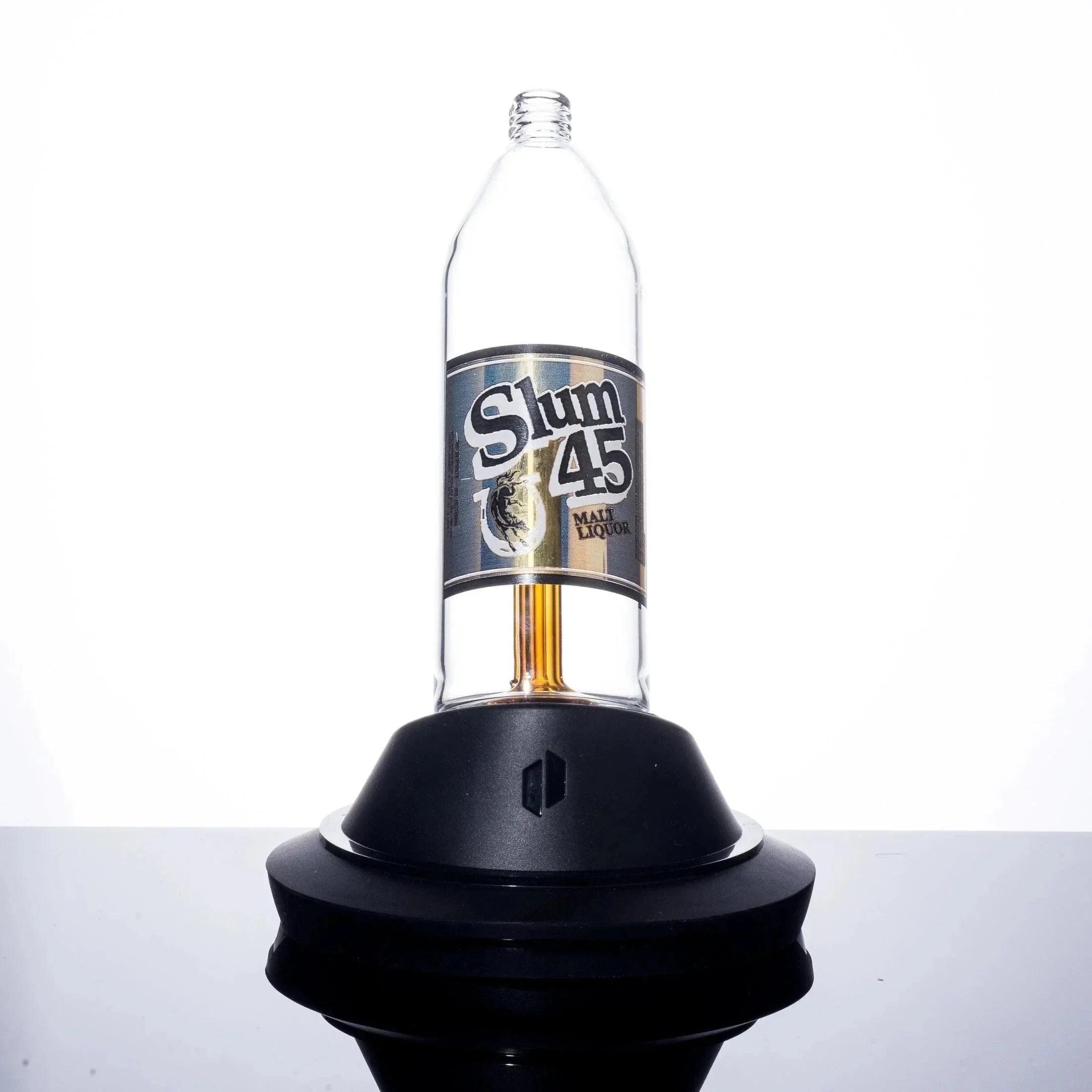 Slum 45 Malt Liquor bottle on black base, clear glass design with bold label