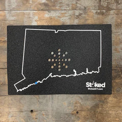 Mood mat on wood background with State of Connecticut outline and stoked logo, bottom right