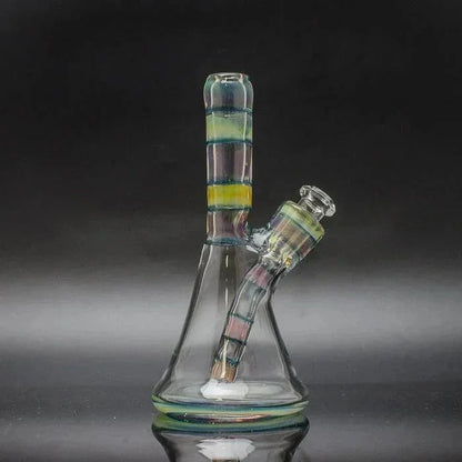 Colorful glass water pipe with removable downstem and striped accents on black background