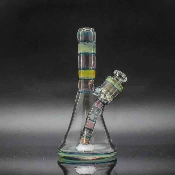 Colorful glass water pipe with removable downstem and striped accents on black background