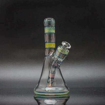 Glass water pipe with removable downstem and colorful striped accents on black background