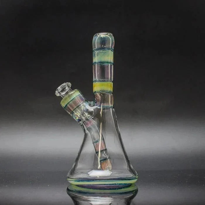 Colorful glass beaker water pipe with removable downstem and striped accents on black background