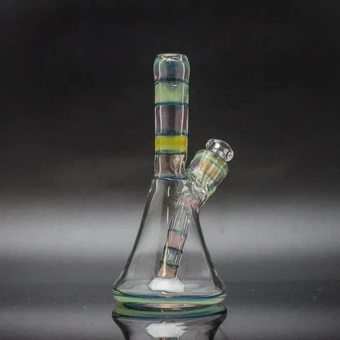 Colorful glass water pipe with removable downstem and bubble cap on black background