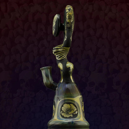 Intricate glass water pipe with floral engraving and sculpted figure design